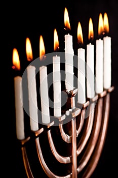 Lit hanukkah menorah black background.