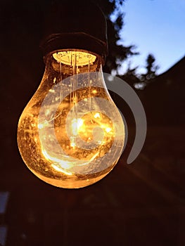 Lit Light bulb at dusk