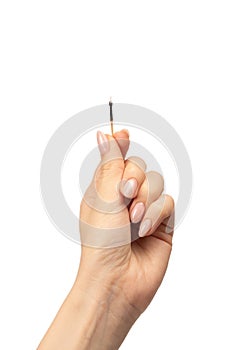 Lit match in a woman hand isolated on a white background