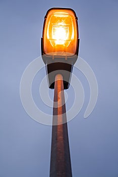 Lit modern streetlamp at evening or early night