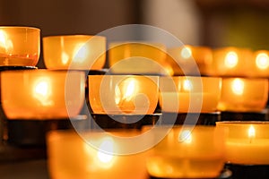 Lit prayer church candles with warm light