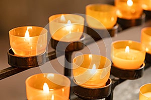 Lit prayer church candles with warm light