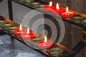 Lit red prayer candles