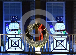 Lit Snowmen on a Front Porch