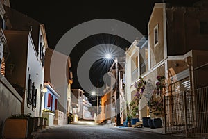 Lit street lights at night in small Greek Assos village located at Kefalonia island, Greece