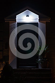 Lit up foyer entryway porch of house at night