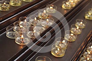 Lit up prayer candles in a church