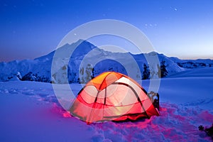 Lit-up Tent on Snow Mountain under Starry Sky photo