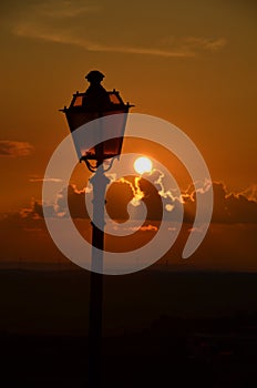 Lit Vertical Lightposts with Sunrise Background