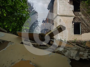 Lit wooden house among the green forest. Flames of fire in the Windows. Danger to the environment