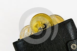 Litecoin, bitcoin and ethereum lie in black leather wallet closeup