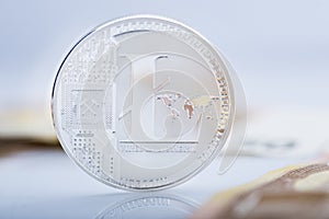 Litecoin on blurry background with selective focus