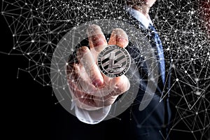 Litecoin coin held out by a man in a suit