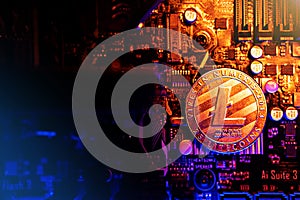 Litecoin Cryptocurrency coin on a PC computer motherboard, crypto currency mining concept