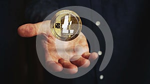 Litecoin LTC cryptocurrency golden 3d coin over hand