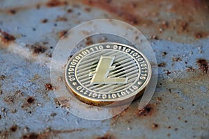A litecoin who belongs between another cryptocurrency on blue and rust steel background. Selling and buying on stock market