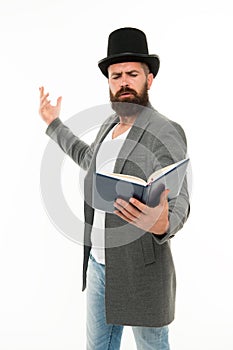 Literary criticism. Faced with senseless drama. Eloquence and diction. Bearded man read book. Poetry reading. Book photo