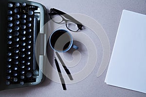 Literature, author and writer, writing and journalism concept: typewriter, cup of coffee and glasses and a paper