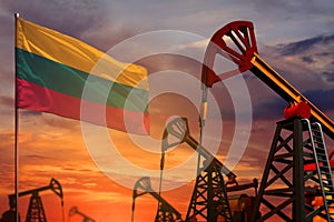 Lithuania oil industry concept. Industrial illustration - Lithuania flag and oil wells with the red and blue sunset or sunrise sky