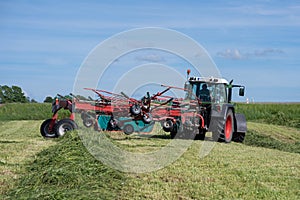 Lithuanian farmer prepare hay rows