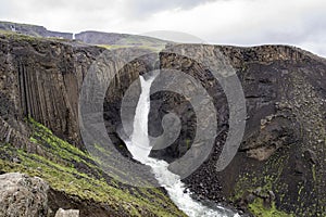 Litlanesfoss waterfall in Iceland with its basaltic geologic landscape in cloudy weather