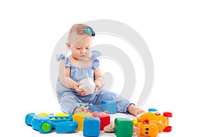 Litle baby girl, playing with toys, isolated