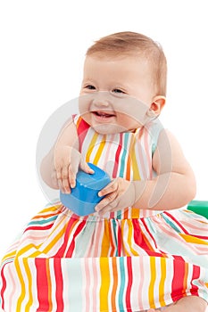 Litle baby girl, smiling, playing with toys, isolated