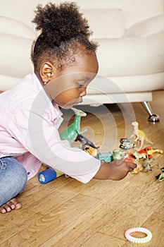 Litle cute sweet african-american girl playing happy with toys at home, lifestyle children concept