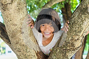Litle girl smile happy on tree