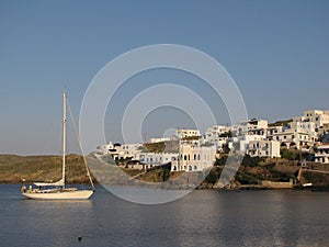 Litle sailing yacht anchored near a greece maritime town.