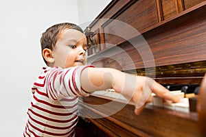 Litlle boy playing the piano