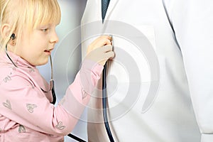 Litlle girl playing doctor with stethoscope