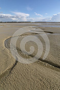 Litlle river flowing on the beach into sea, Somme Bay, Picardy, France