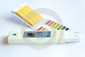 Litmus pH test with color scale and digital conductivity tester