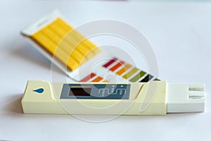 Litmus pH test with color scale and digital conductivity tester