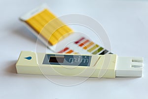 Litmus pH test with color scale and digital conductivity tester