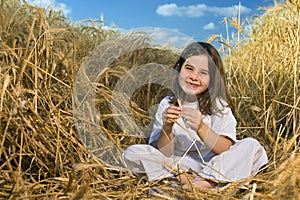 Littel girl in a wheat field