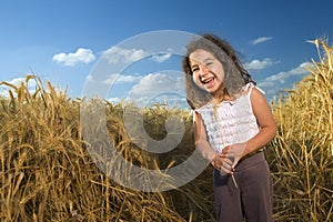 Littel girl in a wheat field