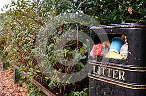 A litter bin trash can in Kelsey Park, Beckenham, Kent, UK