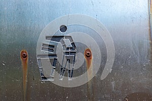 Litter symbol on a old metal rusty surface on a bin outdoor. Keep nature clean concept