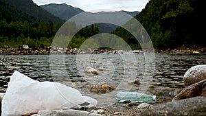 Litter trash in river streaming in forest. iroi garbage bottle and bag waste polluting ecology
