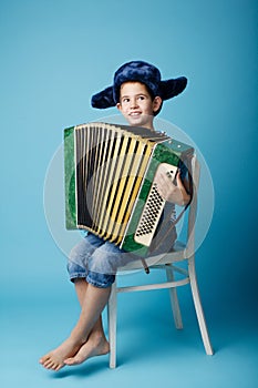 Little accordion player on blue background