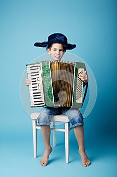 Little accordion player on blue background