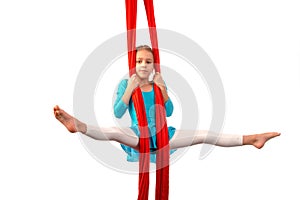 Little acrobat girl doing splits in the air