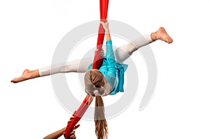 Little acrobat girl doing splits in the air