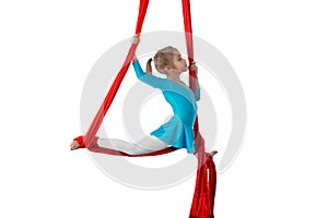Little acrobat girl doing splits in the air