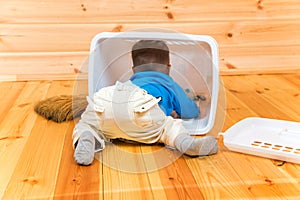 Little active boy helps to clean the house getting inside bin