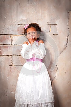 Little actress. Beautiful african girl shows emotions: fear, fright, surprise
