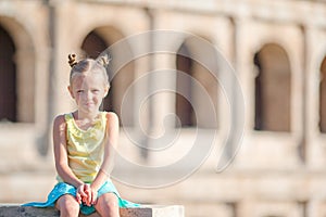 Little adorable girl in front of Colosseum in Rome, Italy