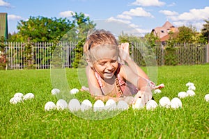 Little adorable girl playing with white Easter